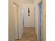 Hallway with neutral tile floors, white walls and white doors at 853 Rusty Anchor Way, Henderson, NV 89002