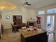 Open-concept living room featuring dining area, fireplace, and sliding doors to the patio at 853 Rusty Anchor Way, Henderson, NV 89002