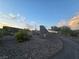 A natural stone retaining wall borders a gravel road highlighting the community's commitment to aesthetics and privacy at 853 Rusty Anchor Way, Henderson, NV 89002