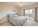 Bright bedroom with a sliding glass door leading to a private balcony and neutral toned walls at 8777 W Maule Ave # 3102, Las Vegas, NV 89148