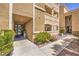 Exterior view of condo entrance with secure door and well-maintained landscaping at 8777 W Maule Ave # 3102, Las Vegas, NV 89148
