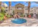 Inviting hot tub area with a decorative waterfall, comfortable seating, and privacy fencing at 8777 W Maule Ave # 3102, Las Vegas, NV 89148