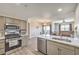 Modern kitchen features stainless steel appliances, quartz countertops, and an open layout to the living area at 8777 W Maule Ave # 3102, Las Vegas, NV 89148