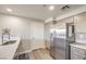 Modern kitchen with stainless steel refrigerator, quartz countertops and neutral paint at 8777 W Maule Ave # 3102, Las Vegas, NV 89148