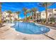 Large community pool surrounded by palm trees and lounge chairs for relaxation and enjoyment at 8777 W Maule Ave # 3102, Las Vegas, NV 89148