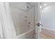 Bathroom with a built-in shelving unit, white tile, and a white shower curtain rod at 9121 Ripple Ridge Ave # 101, Las Vegas, NV 89149