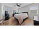 Spacious bedroom with hardwood floors, ceiling fan, and large window for natural light at 9121 Ripple Ridge Ave # 101, Las Vegas, NV 89149