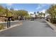 Gated community entrance with black iron gates and lush landscaping at 9121 Ripple Ridge Ave # 101, Las Vegas, NV 89149