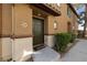 Exterior view of the front door of the home with manicured landscaping at 9121 Ripple Ridge Ave # 101, Las Vegas, NV 89149