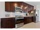 Modern kitchen with stainless steel appliances and dark wood cabinetry at 9121 Ripple Ridge Ave # 101, Las Vegas, NV 89149