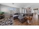 Open-concept living room with wood floors, large windows, and modern décor at 9121 Ripple Ridge Ave # 101, Las Vegas, NV 89149