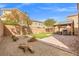 Spacious backyard featuring a covered patio, artificial grass, and xeriscaping at 9144 Irish Elk Ave, Las Vegas, NV 89149