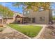 Inviting backyard with a covered patio and lush artificial grass at 9144 Irish Elk Ave, Las Vegas, NV 89149