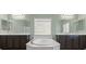 Elegant bathroom featuring dual sinks, a large soaking tub, and modern lighting at 9144 Irish Elk Ave, Las Vegas, NV 89149