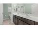 Bathroom featuring double sinks with dark cabinets and a toilet at 9144 Irish Elk Ave, Las Vegas, NV 89149