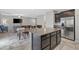 Kitchen with granite island open to the dining and living areas with tile floors at 9144 Irish Elk Ave, Las Vegas, NV 89149