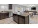 Kitchen island with granite countertop, dark wood cabinets, and tile flooring at 9144 Irish Elk Ave, Las Vegas, NV 89149