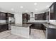 Bright kitchen featuring dark wood cabinets, granite countertops, and stainless steel appliances at 9144 Irish Elk Ave, Las Vegas, NV 89149