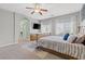 Main bedroom with ceiling fan, tv, carpet, and furniture at 9144 Irish Elk Ave, Las Vegas, NV 89149