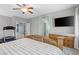 Spacious bedroom featuring a ceiling fan, television, and wood dresser at 9144 Irish Elk Ave, Las Vegas, NV 89149