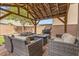 Covered patio area featuring an outdoor fireplace and comfortable seating at 9144 Irish Elk Ave, Las Vegas, NV 89149