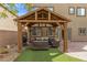 Covered patio area with outdoor kitchen setup and cozy seating area at 9144 Irish Elk Ave, Las Vegas, NV 89149