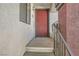 Entryway to a condo with a red front door and textured exterior walls at 950 Seven Hills Dr # 424, Henderson, NV 89052