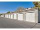 Row of private detached garages with white doors, providing secure parking and extra storage space at 950 Seven Hills Dr # 424, Henderson, NV 89052