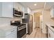Bright kitchen featuring stainless steel appliances and white cabinets at 950 Seven Hills Dr # 424, Henderson, NV 89052