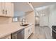 Modern kitchen with stainless steel dishwasher and hardware, opening up to the dining area at 950 Seven Hills Dr # 424, Henderson, NV 89052