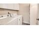 Practical laundry area with washer, dryer, and storage shelving at 950 Seven Hills Dr # 424, Henderson, NV 89052