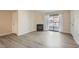 Living room featuring a fireplace, sliding glass door to balcony and wood-look floors at 950 Seven Hills Dr # 424, Henderson, NV 89052