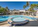 Community pool and spa surrounded by lush palms, offering a resort-style experience for residents at 950 Seven Hills Dr # 424, Henderson, NV 89052
