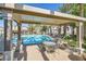 Relax in the shaded seating area by the pool, perfect for enjoying the community's resort-style amenities at 950 Seven Hills Dr # 424, Henderson, NV 89052