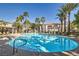 Community pool and spa surrounded by lush palms, offering a resort-style experience for residents at 950 Seven Hills Dr # 424, Henderson, NV 89052