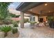 This spacious back patio has a ceiling fan, outdoor seating, pavers, and plenty of room for entertaining at 9889 Gemstone Sunset Ave, Las Vegas, NV 89148