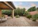 Private backyard featuring manicured landscaping and relaxing seating area at 9889 Gemstone Sunset Ave, Las Vegas, NV 89148