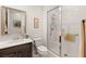 Clean bathroom featuring a walk-in glass shower, white tiled walls, and updated fixtures at 9889 Gemstone Sunset Ave, Las Vegas, NV 89148