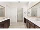 Elegant bathroom featuring double sinks, sleek countertops, and a glass-enclosed shower at 9889 Gemstone Sunset Ave, Las Vegas, NV 89148
