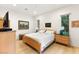 Bright bedroom features hardwood floors, natural light, and neutral decor, creating a serene and inviting atmosphere at 9889 Gemstone Sunset Ave, Las Vegas, NV 89148