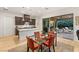 Bright kitchen next to covered patio with stainless appliances, center island, and sleek wood floors at 9889 Gemstone Sunset Ave, Las Vegas, NV 89148