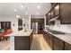 Well-lit kitchen with stainless steel appliances, wood cabinets, and granite countertops offers style and functionality at 9889 Gemstone Sunset Ave, Las Vegas, NV 89148
