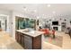 Bright, open kitchen flowing to dining and living areas with stainless appliances and backyard patio access at 9889 Gemstone Sunset Ave, Las Vegas, NV 89148