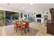 Bright living room with fireplace, modern decor, and access to outdoor patio at 9889 Gemstone Sunset Ave, Las Vegas, NV 89148