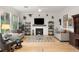 Cozy living room with fireplace, modern decor, and ample natural light at 9889 Gemstone Sunset Ave, Las Vegas, NV 89148