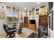 Spacious home office with large window, built-in shelving, and comfortable seating area at 9889 Gemstone Sunset Ave, Las Vegas, NV 89148