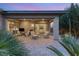 Covered patio with pavers, outdoor seating, a ceiling fan, and landscaped backyard, ideal for outdoor living at 9889 Gemstone Sunset Ave, Las Vegas, NV 89148
