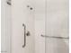 Shower area with hand rails and glass door at 9889 Gemstone Sunset Ave, Las Vegas, NV 89148
