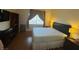 Well-lit bedroom with wood-look floors, a large window and a desk area at , Las Vegas, NV 89102