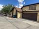Two-story home featuring a brown two-car garage and neutral-colored stucco siding at , Las Vegas, NV 89102
